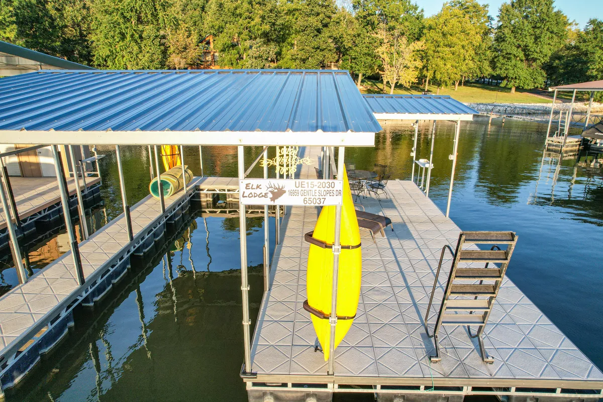 A close-up of a bright yellow kayak resting on a welcoming dock, with shimmering reflections in the water. The scene is bathed in soft, natural light, inviting adventure and peaceful exploration.